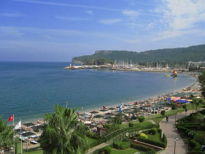 Kemer beach on the Antalya coast with mountains behind the bay
